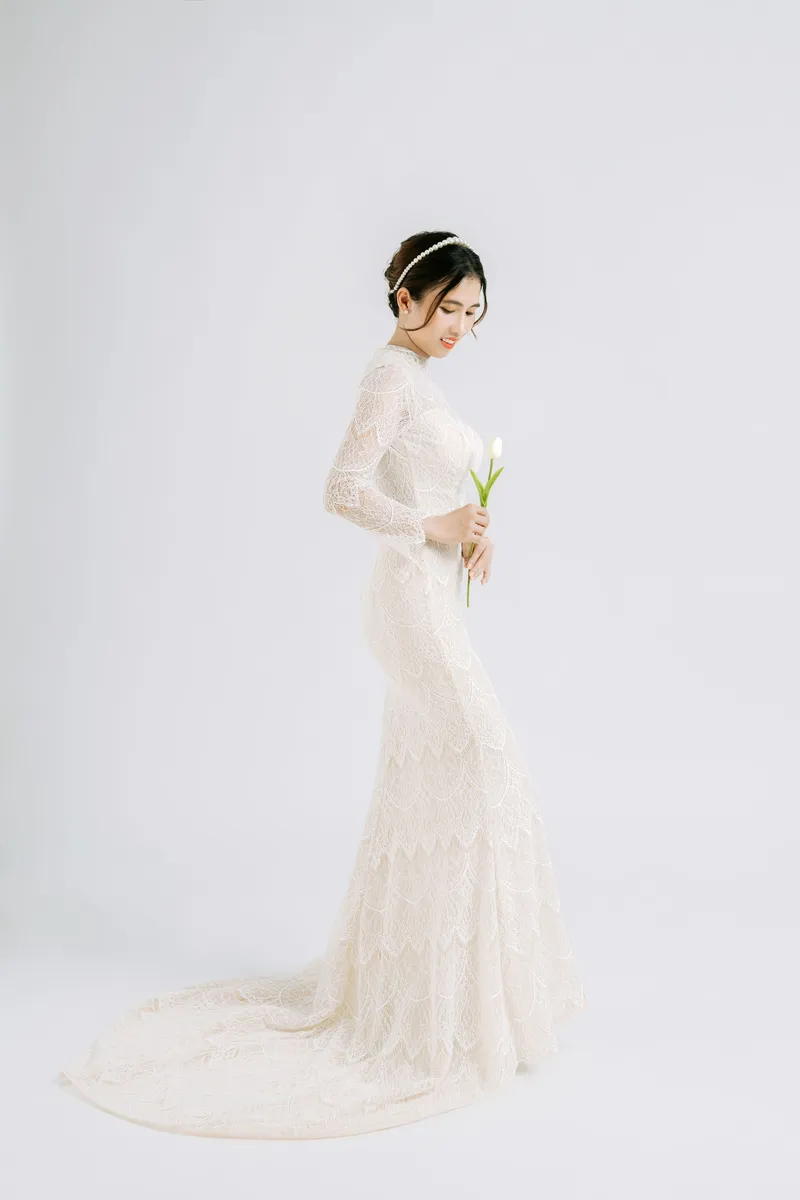 Fitted lace gown with long sleeves and a train