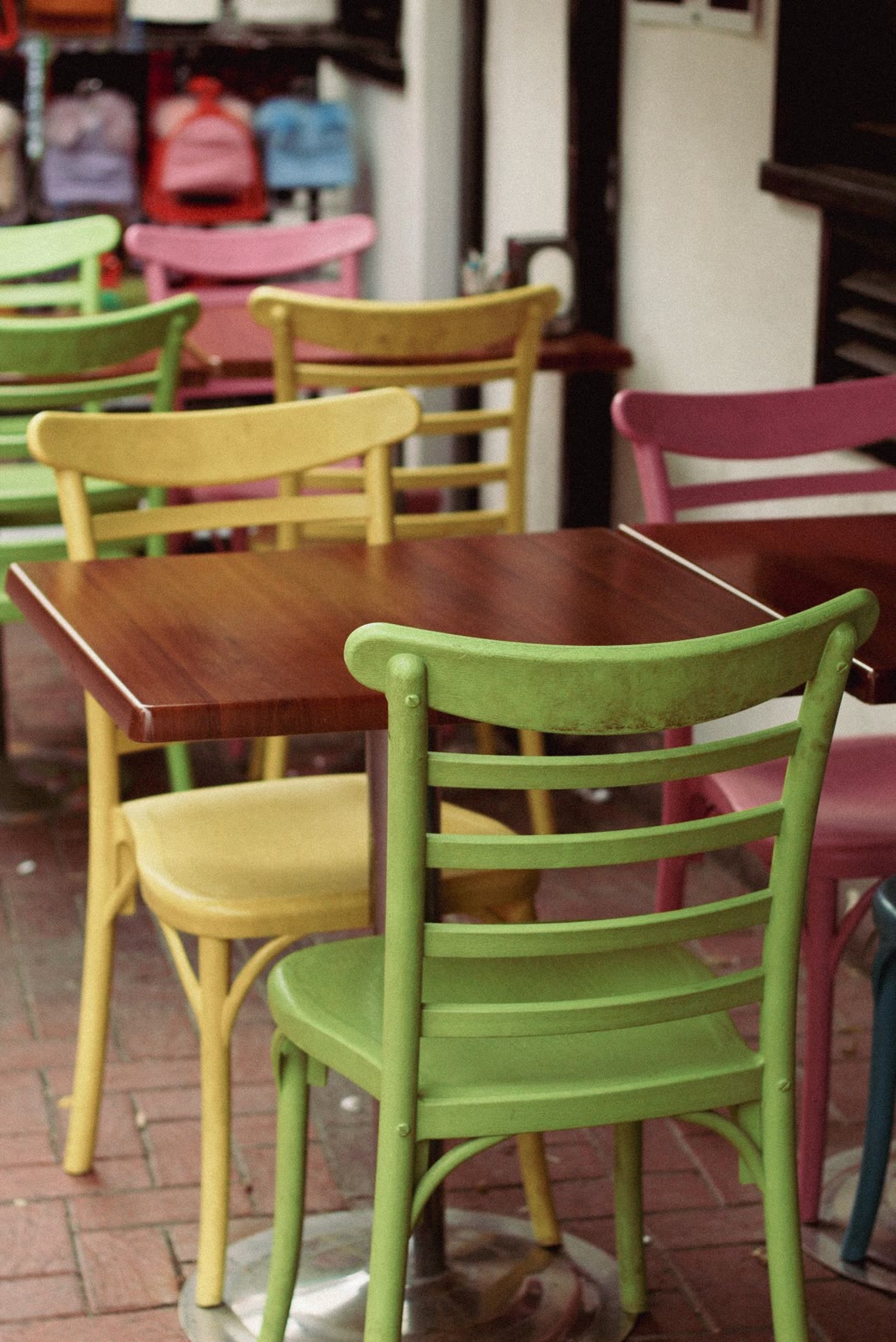 Mismatched yellow, green and pink café chairs