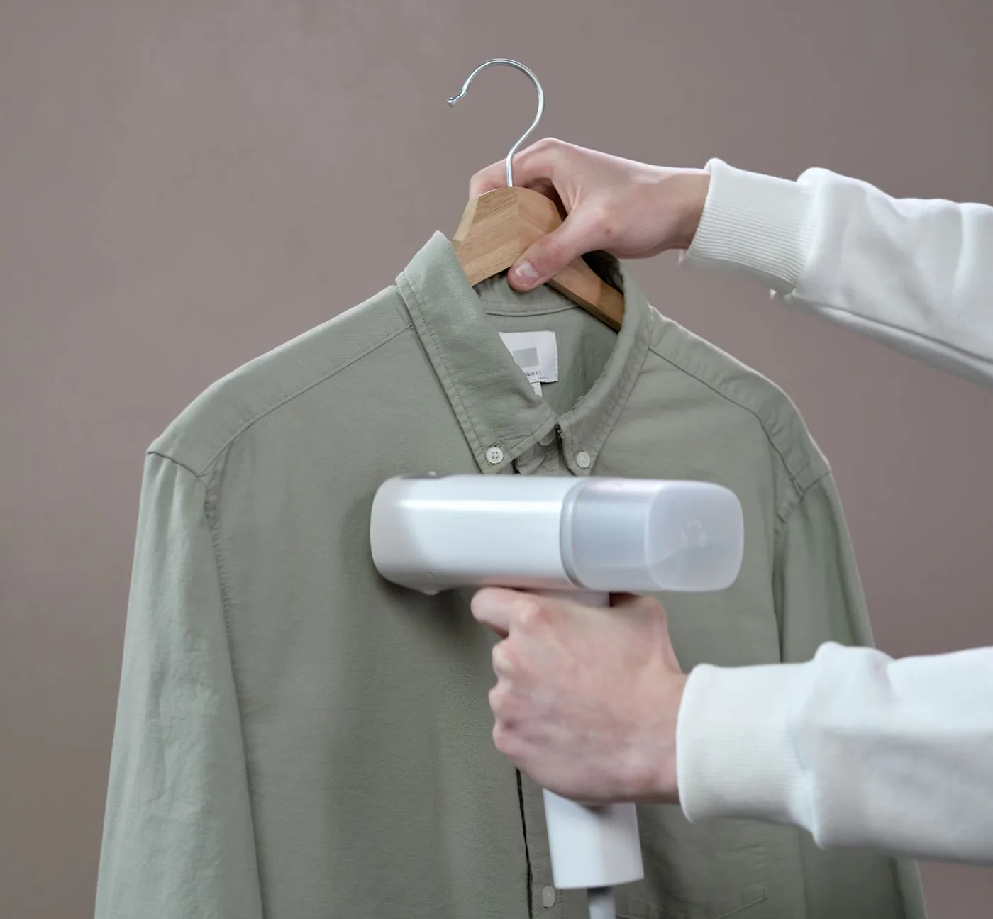 The shirt being steamed on its hanger after the dye bath
