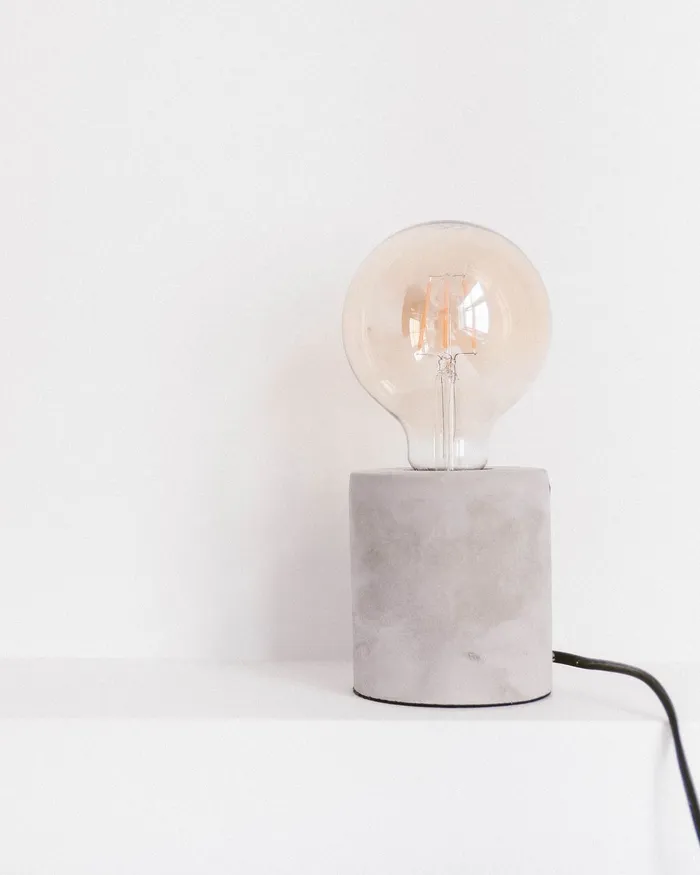 Concrete table lamp with a bare bulb