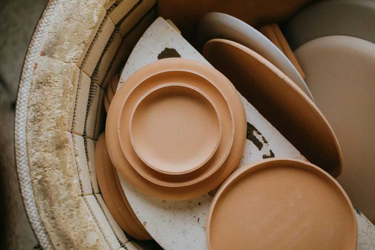 Terracotta plates stacked inside the kiln