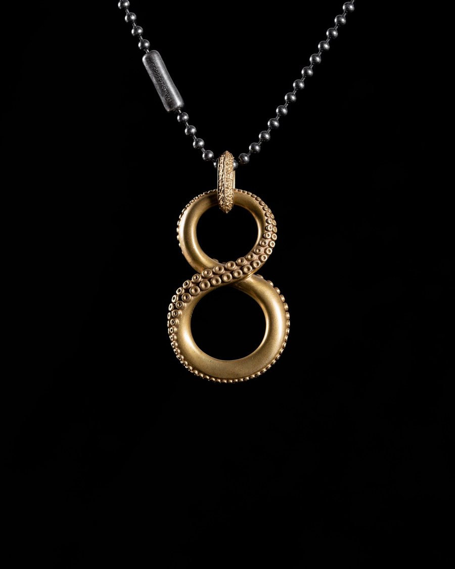 Gold figure eight pendant on a fine chain