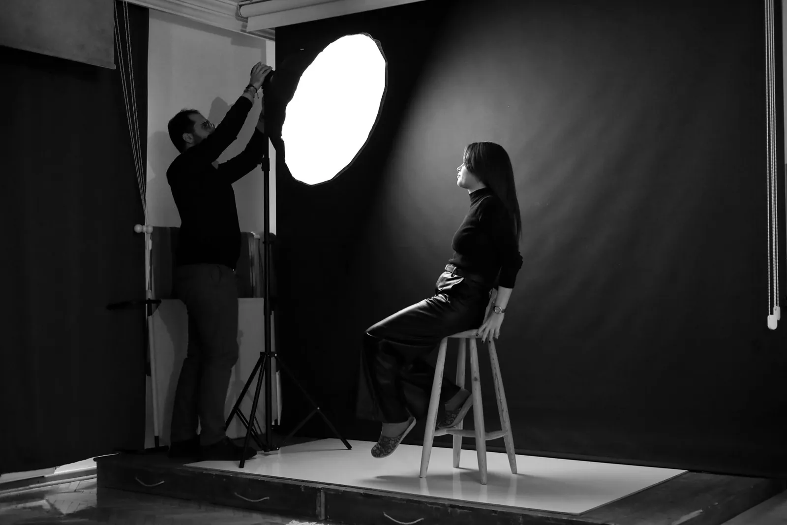 The studio with a black backdrop and a large flash