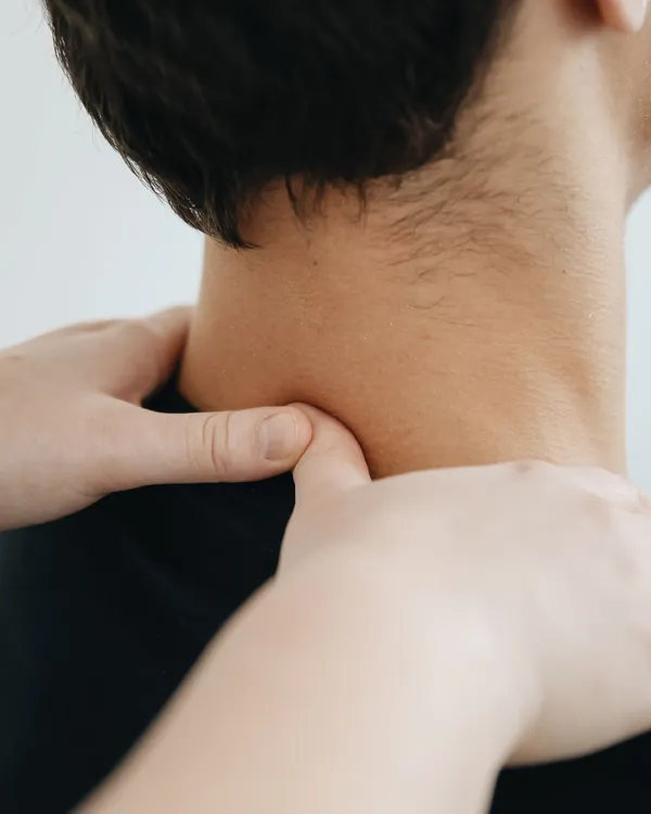 Therapist's hands working on a patient's shoulder