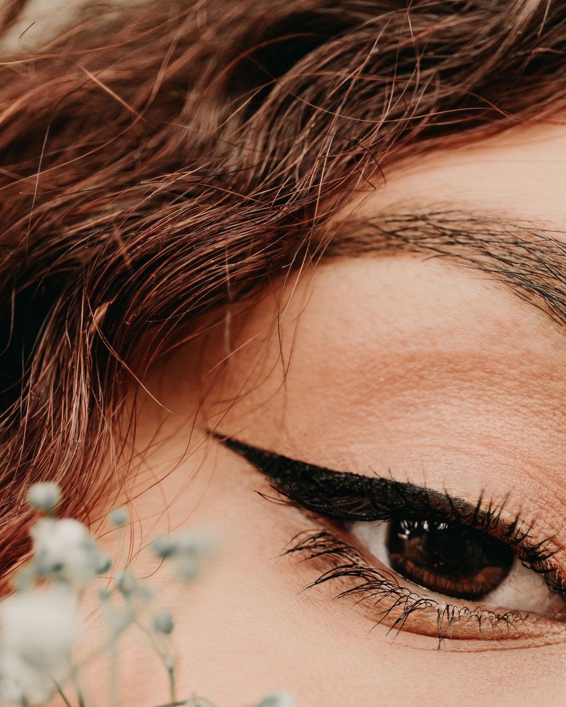 A crisp winged liner on a fair, freckled face