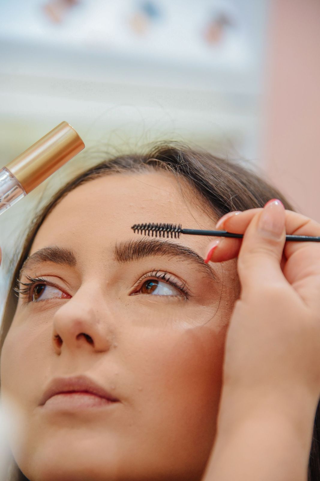 Brows being brushed up and set